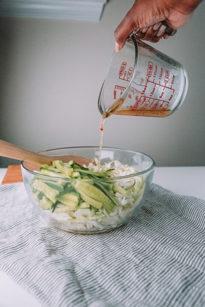 10 ingredient Cucumber Cabbage Slaw is a quick and healthy side dish that pairs with sandwiches, hotdog. Recipe from Mash and Spread. 