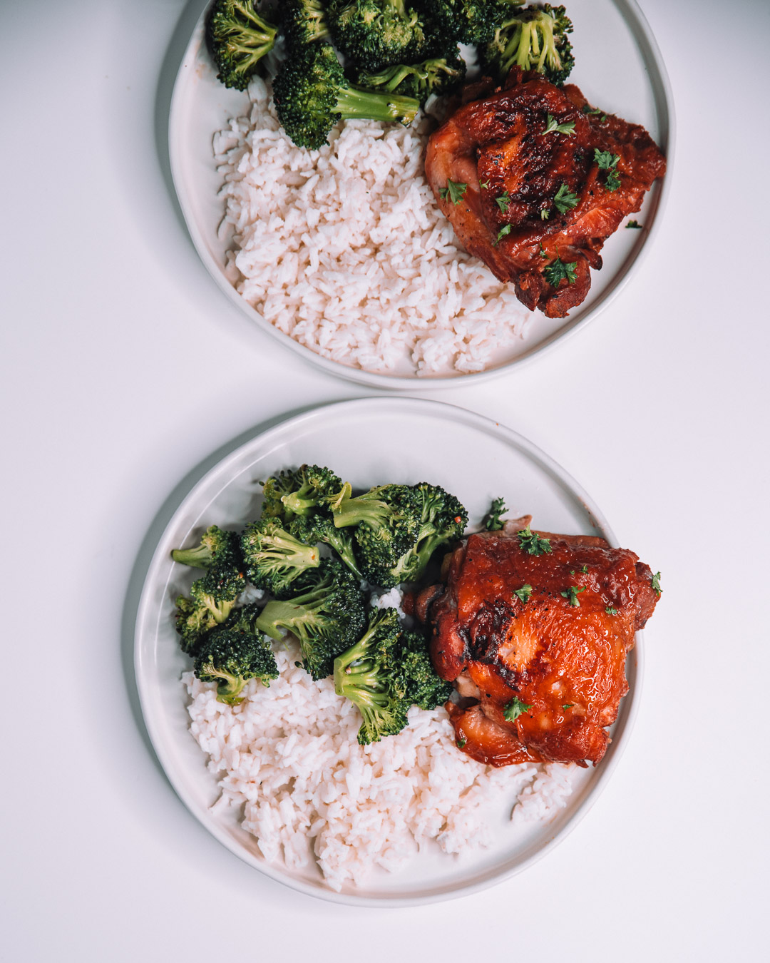 Instant Pot Honey Garlic Chicken on white round plate with a bed of white rice and freshly roasted green broccoli.