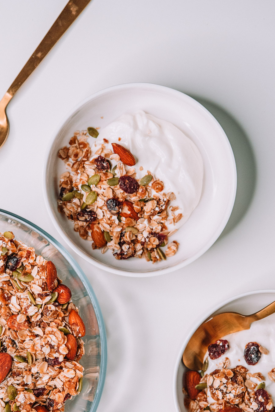 2 Yogurt bowls with freshly made granola on a white table