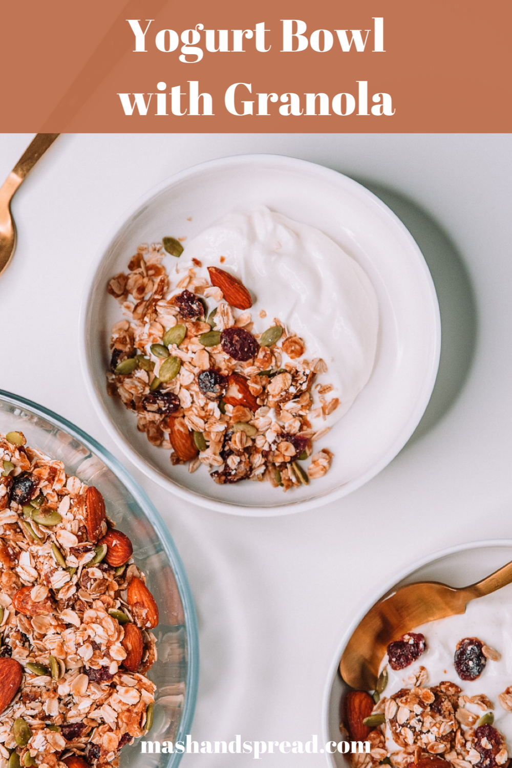 2 yogurt bowls with freshly made granola on a white table