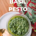 Pesto sauce in a food processor with red scraper spatula
