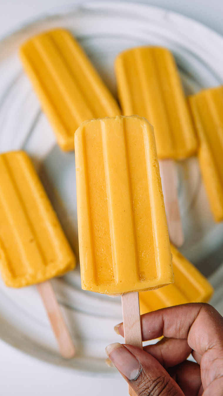 Hand holding a Mango Lassi Popsicles