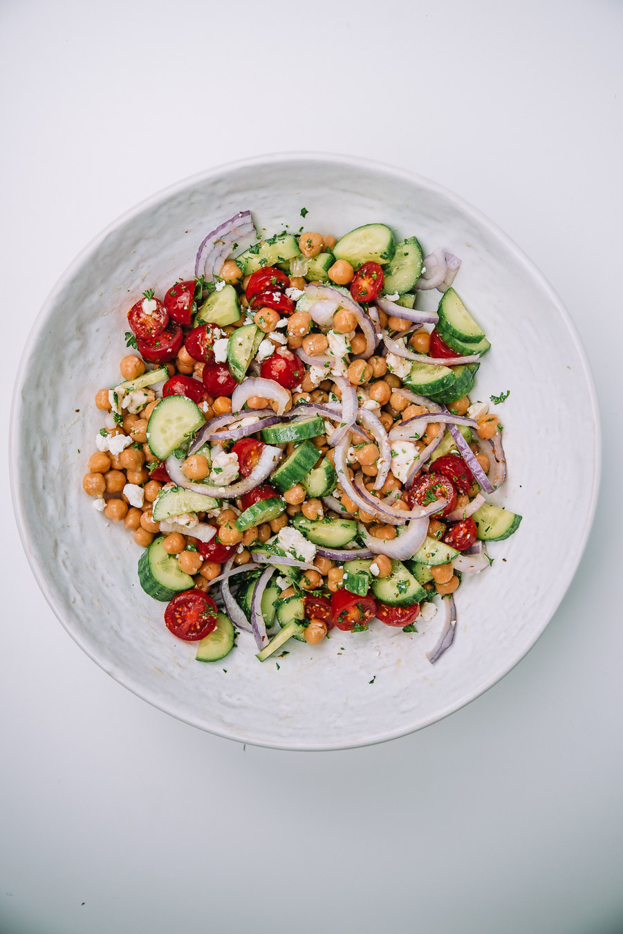 Bowl of Mediterranean Chickpea Salad on a white table