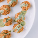 salmon meatballs on a white plate.