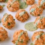 salmon meatballs on a white plate.