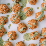 salmon meatballs on a white plate.