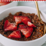 Looking to switch it up with a quick breakfast recipe? Make this easy healthy chocolatey thick batch of chocolate oatmeal made with chia seeds and topped with fresh strawberries. #chocolate #strawberry #oatmeal #breakfast