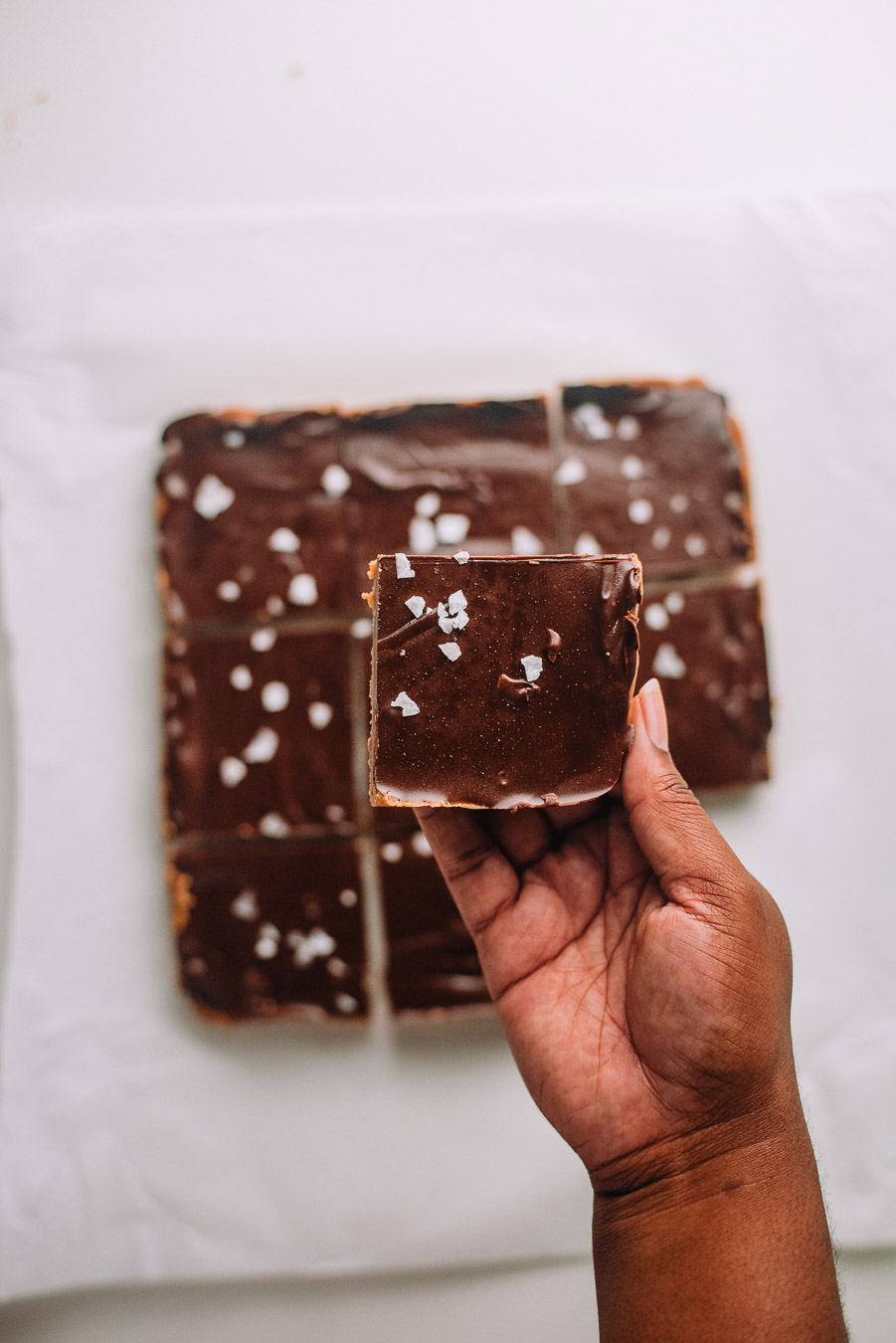 Hand holding No Bake Peanut Butter Chocolate Bars 