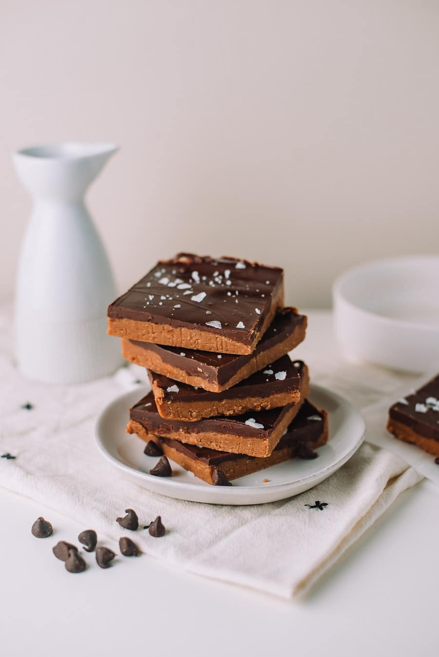 No Bake Peanut Butter Chocolate Bars stacked on a white plate