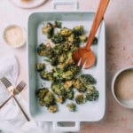 Oven roasted parmesan broccoli in a white baking pan on a table