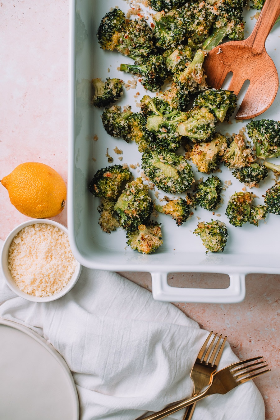 Roasted Parmesan Broccoli in a white baking dish placed with a white towel