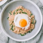 Bowl of Savory Spinach Oatmeal with Fried Eggs