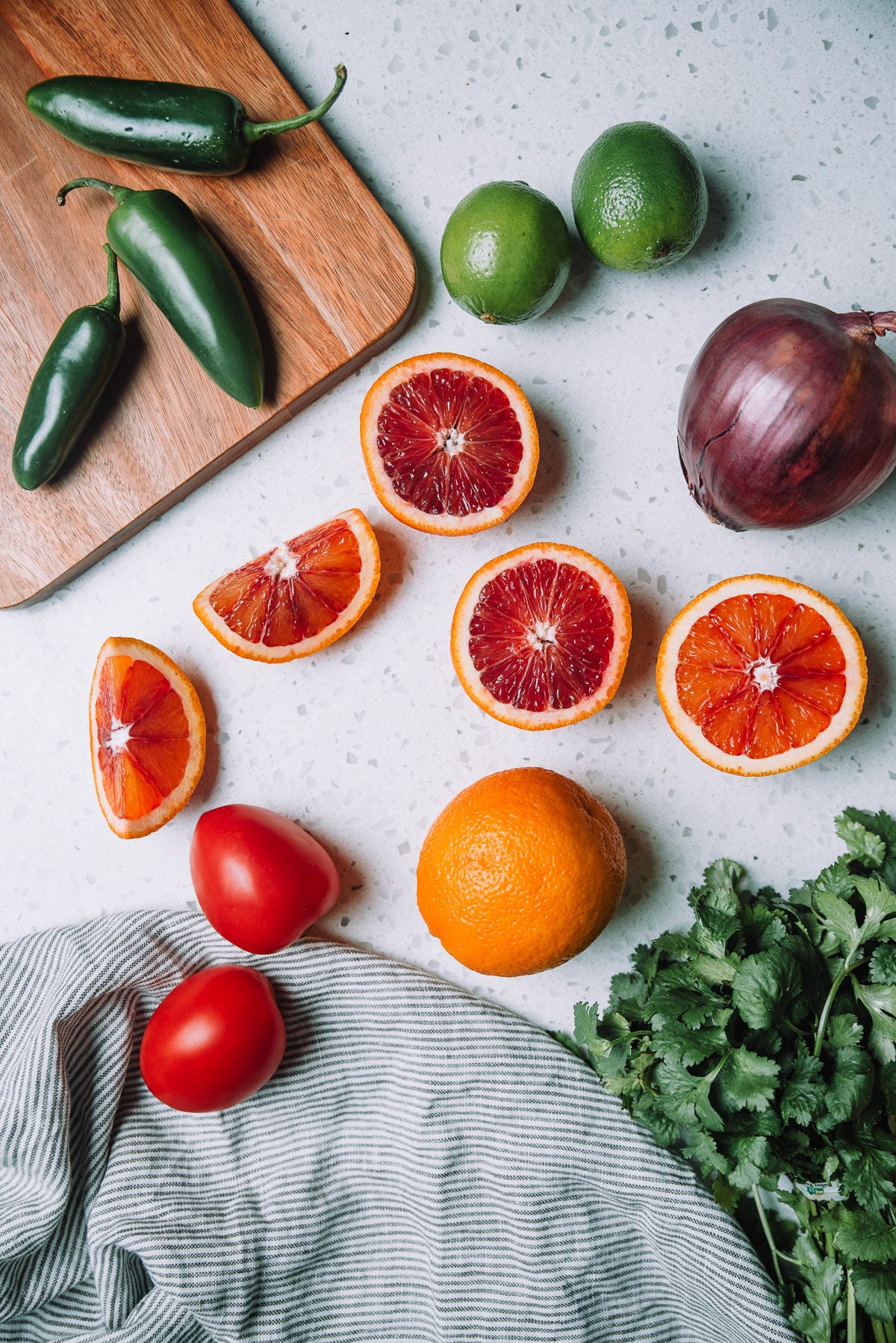 Ingredients of Chunky Blood Orange Salsa on a countertop