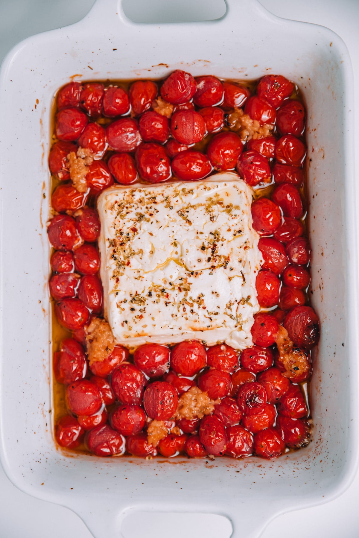 Roasted cherry tomatoes with garlic and melted feta cheese with seasonings