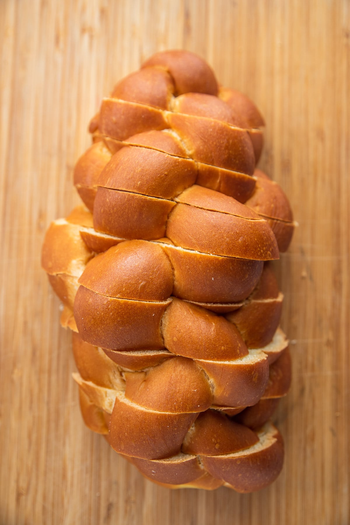 A loaf of challah bread cut into thick slices