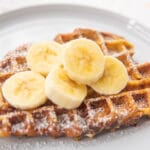 French toast waffle with powdered sugar and bananas